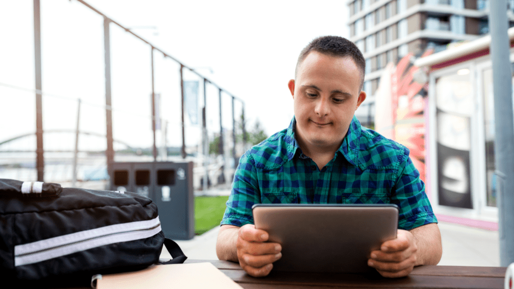 older-teen-down-syndrome-reading-tablet-guardianship