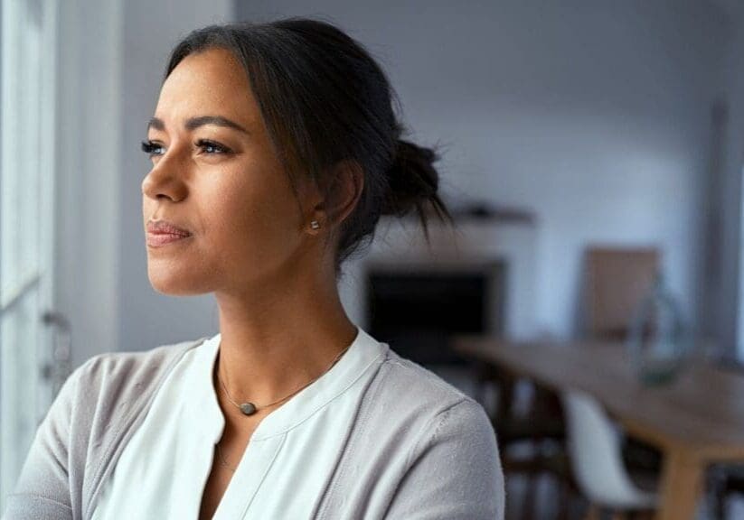 woman-looking-outside-window-thinking-life